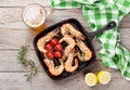 Grilled shrimps on frying pan and beer Royalty Free Stock Photo