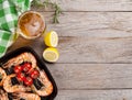 Grilled shrimps on frying pan and beer Royalty Free Stock Photo