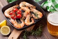 Grilled shrimps on frying pan and beer Royalty Free Stock Photo