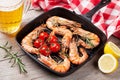 Grilled shrimps on frying pan and beer Royalty Free Stock Photo