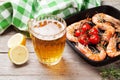 Grilled shrimps on frying pan and beer Royalty Free Stock Photo