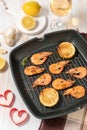 Grilled shrimps on a grill frying pan with wine Royalty Free Stock Photo