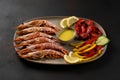 Grilled shrimps on plate with lemon slice and vegetables. Seafood background Royalty Free Stock Photo