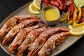 Grilled shrimps on plate with lemon slice and vegetables. Seafood background Royalty Free Stock Photo