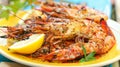 Grilled shrimps on a plate are served with lemon and spices, Ai Generated