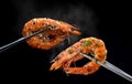 Grilled shrimps prawn with chopsticks