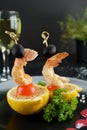 Grilled shrimps served on a toothpick with black olive and cherry tomato. Royalty Free Stock Photo