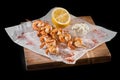 Grilled shrimps on skewers close-up of a blackboard. vertical, black background. Royalty Free Stock Photo