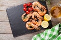 Grilled shrimps on stone plate and beer mug Royalty Free Stock Photo
