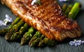 Grilled Sirloin beef steak on fried asparagus served on black slate plate with rosemary flowers Royalty Free Stock Photo