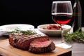 grilled sirloin steak next to a glass of red wine
