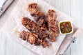 Grilled sirloin tips or beef meat skewers with chimichurri sauce, on wooden tray, horizontal, top view