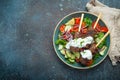 Grilled skewer meat beef kebabs on sticks served with fresh vegetables salad on plate on rustic concrete background from Royalty Free Stock Photo