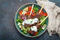 Grilled skewer meat beef kebabs on sticks served with fresh vegetables salad on plate on rustic concrete background from Royalty Free Stock Photo