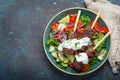 Grilled skewer meat beef kebabs on sticks served with fresh vegetables salad on plate on rustic concrete background from Royalty Free Stock Photo