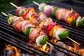 grilled skewered scallops wrapped in bacon on a barbeque Royalty Free Stock Photo