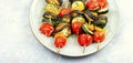 Plate with tasty vegetable skewers Royalty Free Stock Photo
