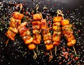 Grilled skewers with pineapple fruit and chicken meat  with sriracha sauce, sprinkled with sesame seeds, chilli pepper and fresh h Royalty Free Stock Photo