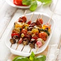 Grilled skewers of vegetables and meat in a herb marinade on white plate Royalty Free Stock Photo