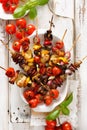 Grilled skewers of vegetables and meat in a herb marinade on white plate Royalty Free Stock Photo