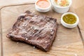 Grilled Skirt Steak with Pickled cabbage and two sauces. Serving on a wooden Board. Barbecue restaurant menu, a series Royalty Free Stock Photo