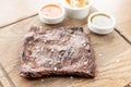 Grilled Skirt Steak with Pickled cabbage and two sauces. Serving on a wooden Board. Barbecue restaurant menu, a series Royalty Free Stock Photo