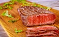 Grilled rare angus beef steak on wooden board Royalty Free Stock Photo