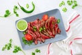 Grilled and sliced rare beef skirt steak served with green chimichurri sauce Royalty Free Stock Photo