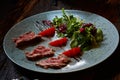 Grilled sliced roast beef and green salad Royalty Free Stock Photo