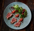 Grilled sliced roast beef and green salad Royalty Free Stock Photo