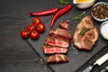 Grilled sliced roated beef steaks on stone serving cutting board Royalty Free Stock Photo