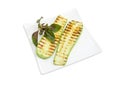 Grilled sliced vegetable marrows on the square white dish Royalty Free Stock Photo
