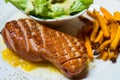 Grilled smoked duck with yellow Mango sauce eat with green salad and sweet potato fried