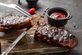 Grilled and smoked ribs with barbeque sauce. Delicious barbecued ribs. Food recipe background. Close up
