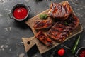 Grilled and smoked ribs with barbeque sauce. Delicious barbecued ribs. Food recipe background. Close up