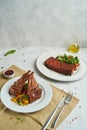 Grilled and smoked ribs with barbeque sauce and salad on light background Royalty Free Stock Photo