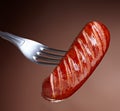 Grilled sausage on a fork Royalty Free Stock Photo