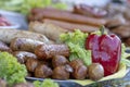 Grilled smoked sausages and meatballs outdoors. Meat baked on the grill bbq. Meat delicacies. Sausages homemade sausages on the Royalty Free Stock Photo