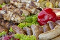 Grilled smoked sausages and meatballs outdoors. Meat baked on the grill bbq. Meat delicacies. Sausages homemade sausages on the Royalty Free Stock Photo