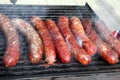 Grilled smoked sausages outdoors. Meat baked on the grill bbq. Meat delicacies. Sausages homemade sausages on the grill. Street fo Royalty Free Stock Photo