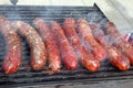 Grilled smoked sausages outdoors. Meat baked on the grill bbq. Meat delicacies. Sausages homemade sausages on the grill. Street fo Royalty Free Stock Photo