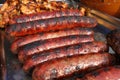 Grilled smoked sausages outdoors. Meat baked on the grill bbq. Meat delicacies. Sausages homemade sausages on the grill. Street fo Royalty Free Stock Photo
