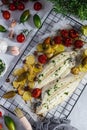 Grilled sole fish with green and red cherry tomatos, potatoe, capers, garlic, parsley and olive oil Royalty Free Stock Photo
