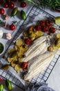 Grilled sole fish with green and red cherry tomatos, potatoe, capers, garlic, parsley and olive oil Royalty Free Stock Photo