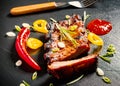 Grilled spareribs on slate plate with cutlery Royalty Free Stock Photo