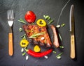 Grilled spareribs on slate plate with cutlery Royalty Free Stock Photo