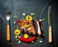 Grilled spareribs on slate plate with cutlery Royalty Free Stock Photo