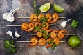 Grilled spicy lime shrimp skewers with creamy avocado garlic cilantro sauce. Top view, overhead, flat lay.