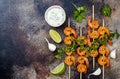 Grilled spicy lime shrimp skewers with creamy avocado garlic cilantro sauce. Top view, overhead, flat lay, copy space. Royalty Free Stock Photo