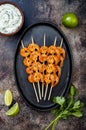 Grilled spicy lime shrimp skewers with creamy avocado garlic cilantro sauce. Top view, overhead, flat lay, copy space. Royalty Free Stock Photo